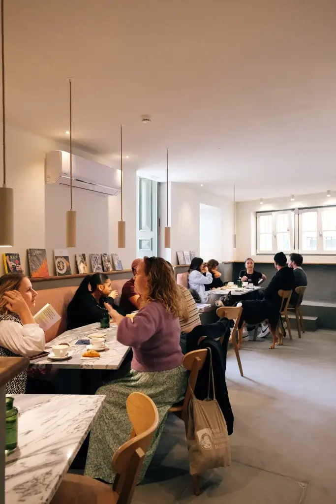 Inside view of Hello, Kristof coffee shop with customers enjoying their drinks and food