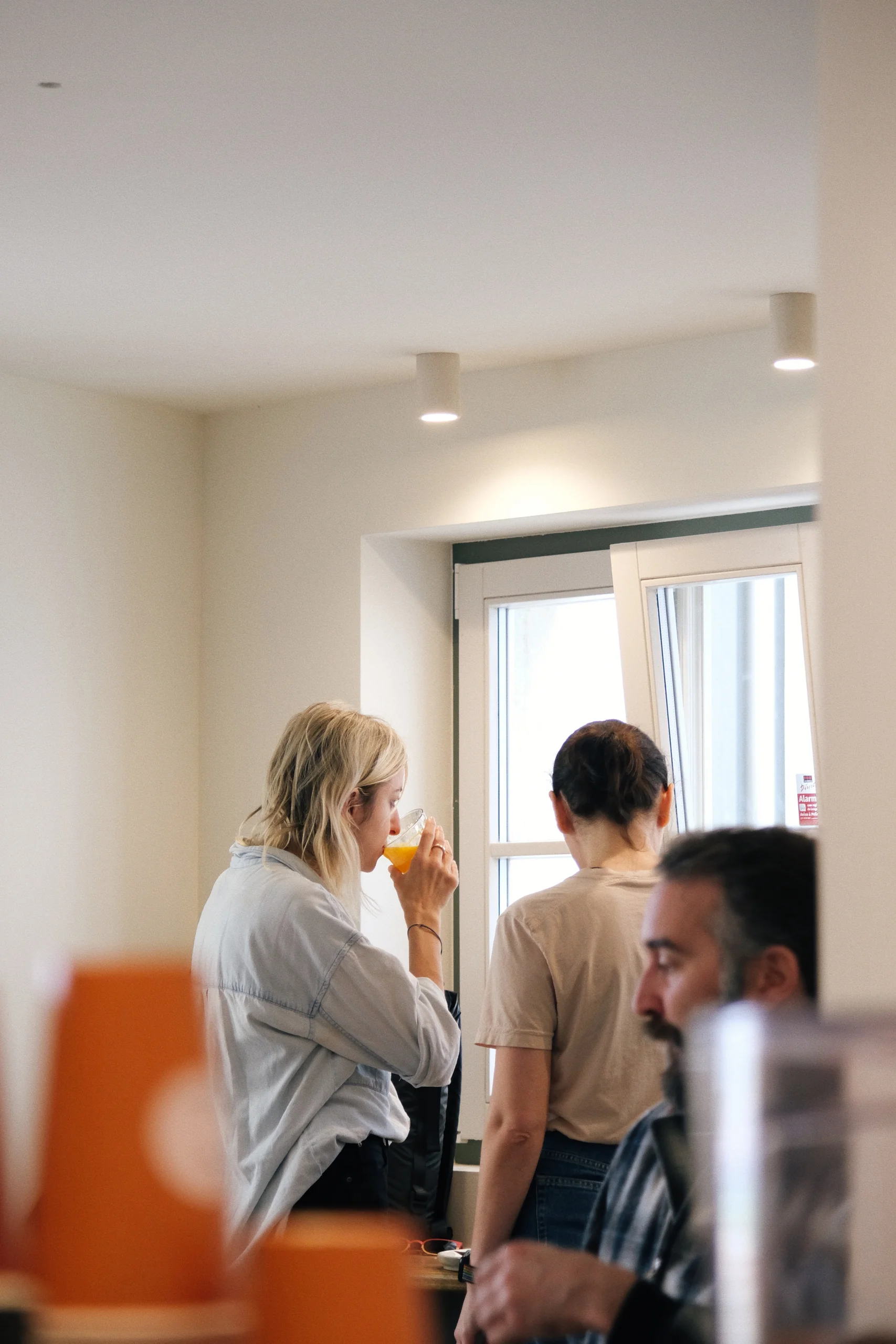 Customers sitting inside Hello, Kristof near a window with natural light