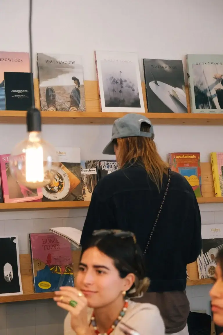 Customer browsing books and magazines on the shelves at Hello, Kristof