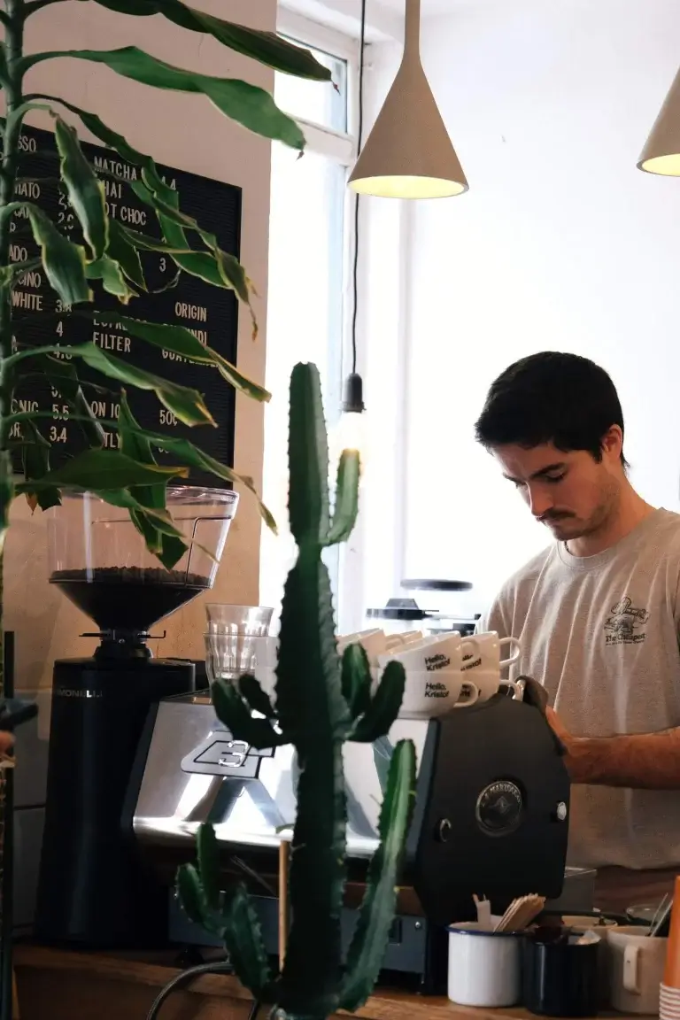 Barista making coffee at the espresso machine at Hello, Kristof